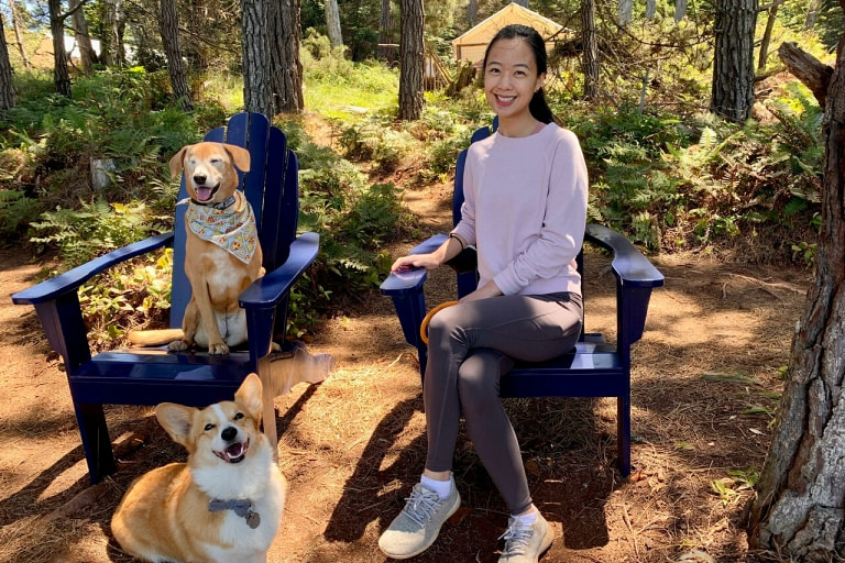 Lesie posing with her dogs at a campsite post-surgery