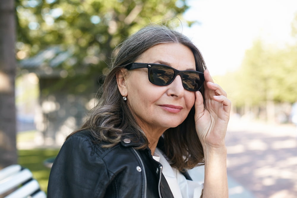 Stylish older woman outside in sunglasses